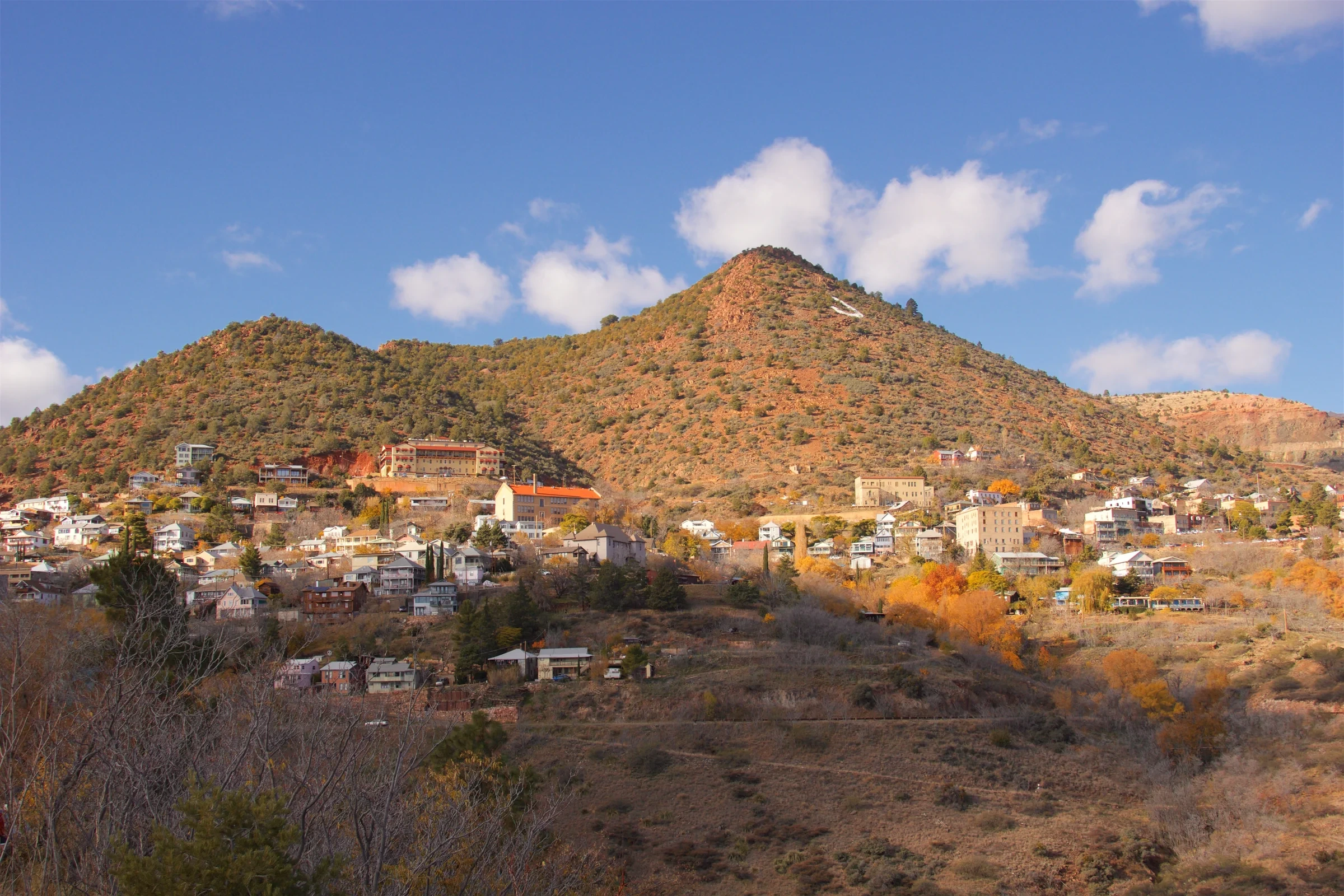 Jerome’s buildings spread across a steep Arizona hillside below a large white J.
