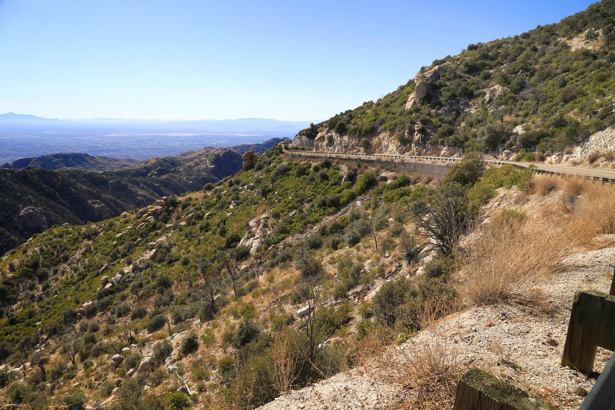 Catalina Highway curves around a rocky mountainside above the Tucson valley.