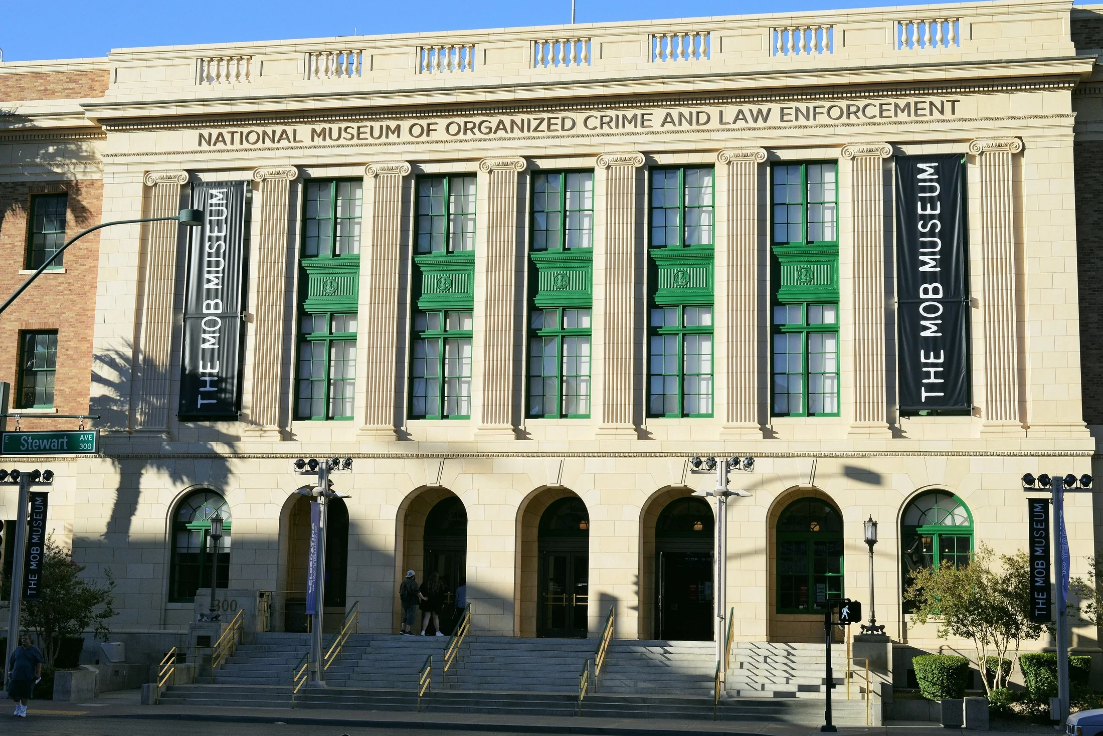 The columned facade, green window frames and entrance steps of the Mob Museum on Stewart Avenue.