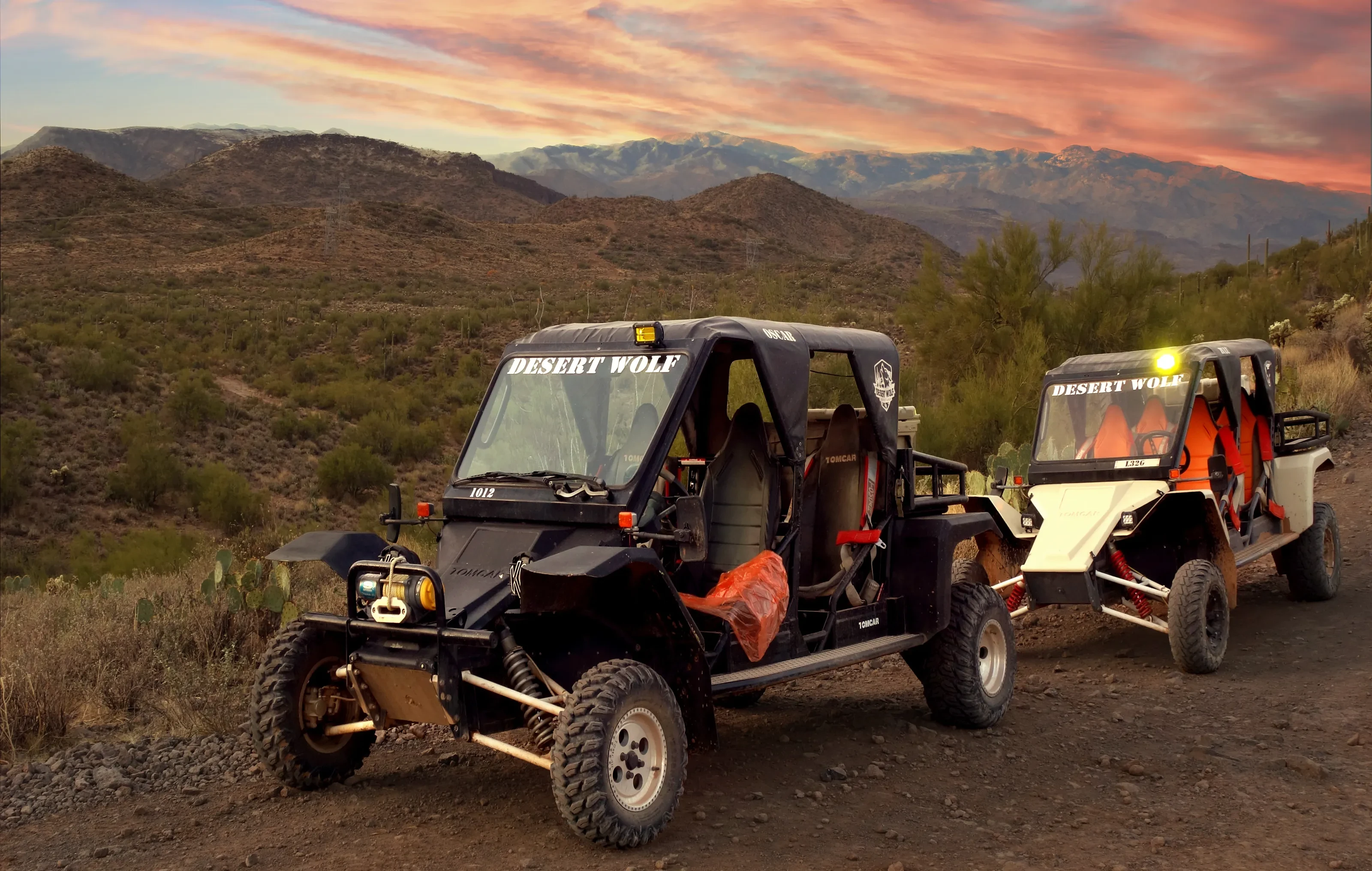 Two off-road touring vehicles on a Sonoran Desert trail near Scottsdale at sunset