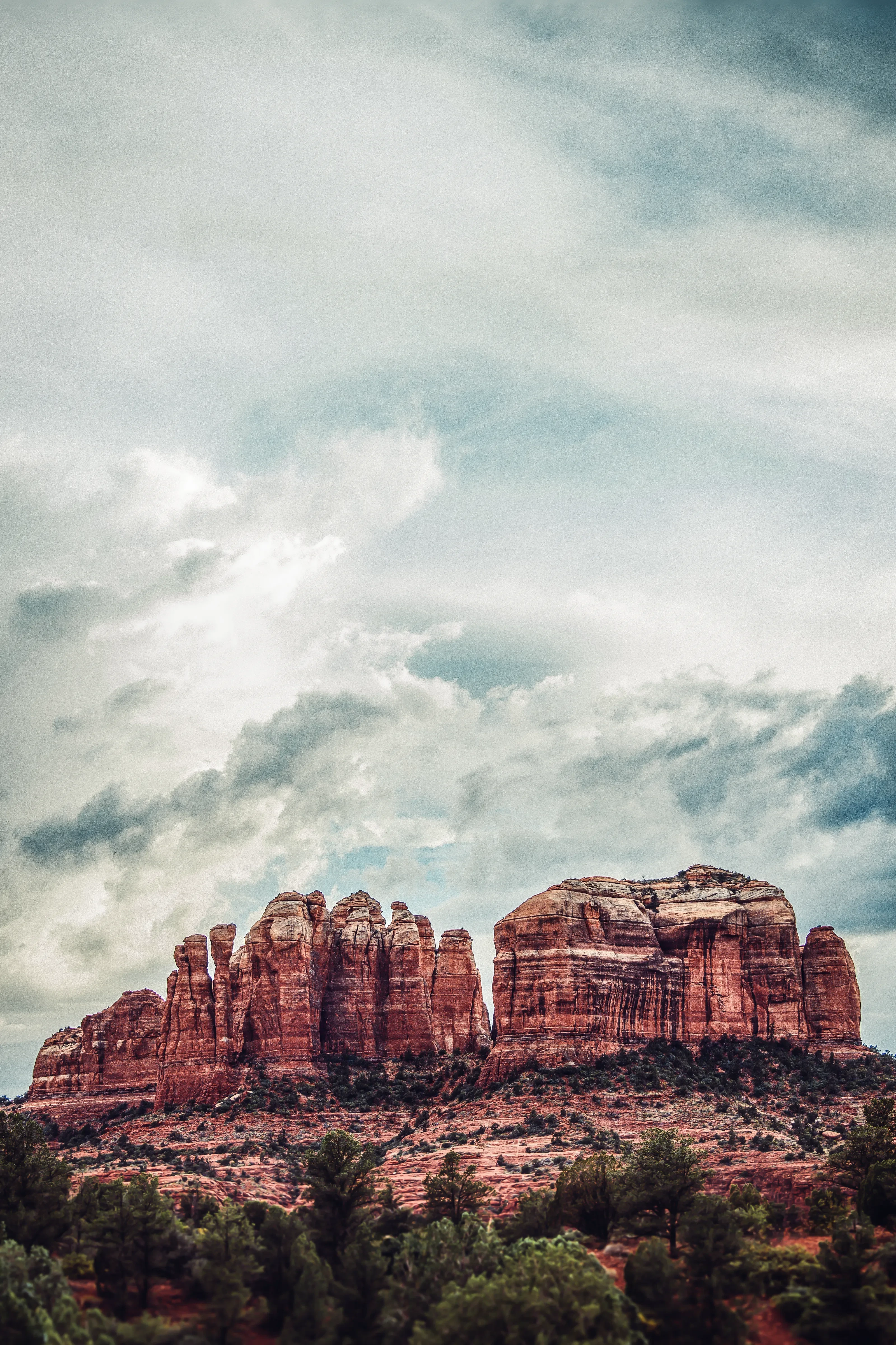 Sculpted red sandstone beneath dramatic clouds at Cathedral Rock in Sedona